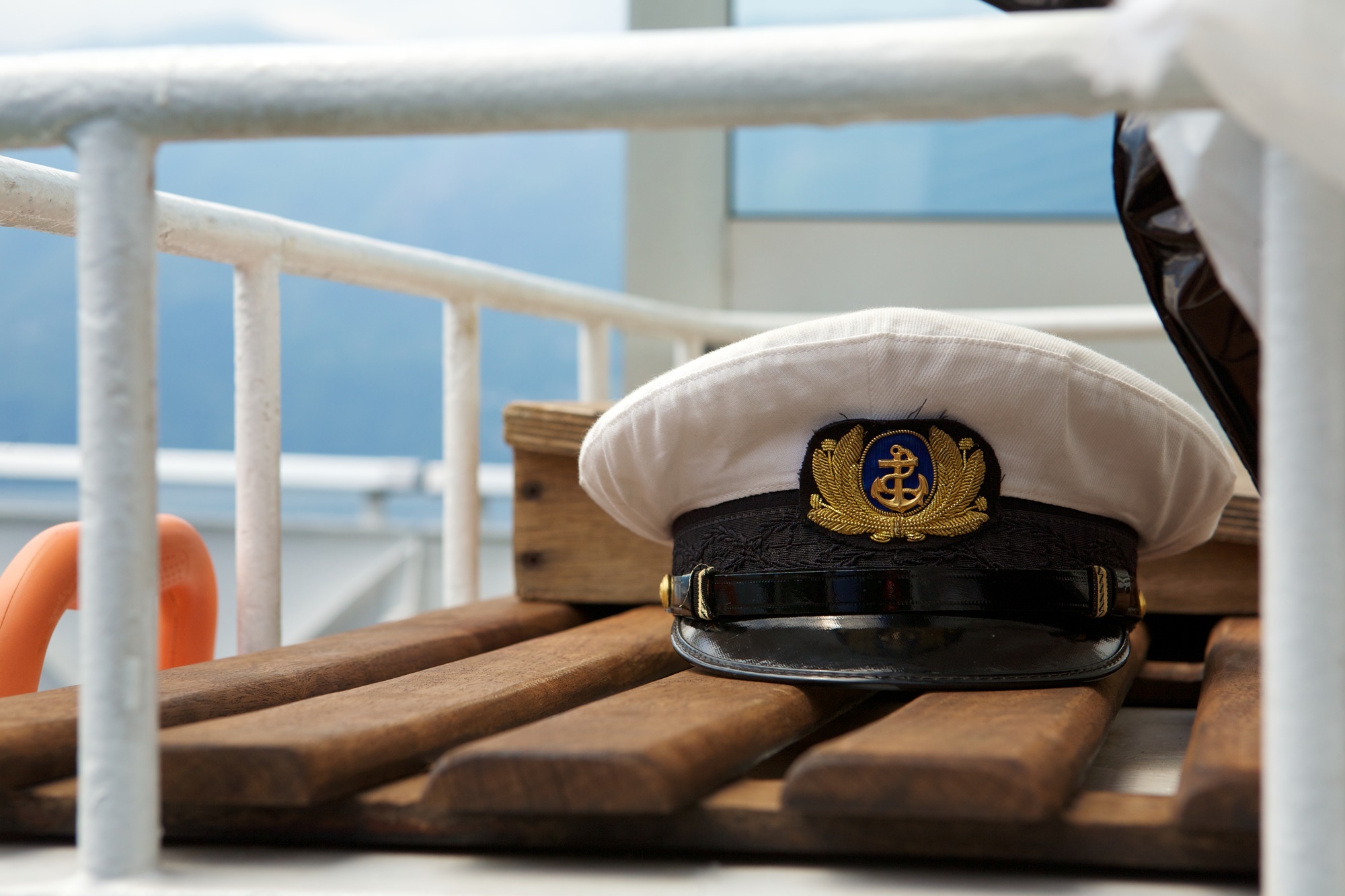 Captains cap on board on a wooden bench